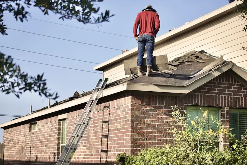Professional roofer working on a residential roof in Great River